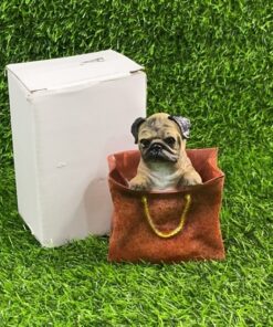 ADORNO CERÁMICO DE PERRO EN BOLSO 1UND